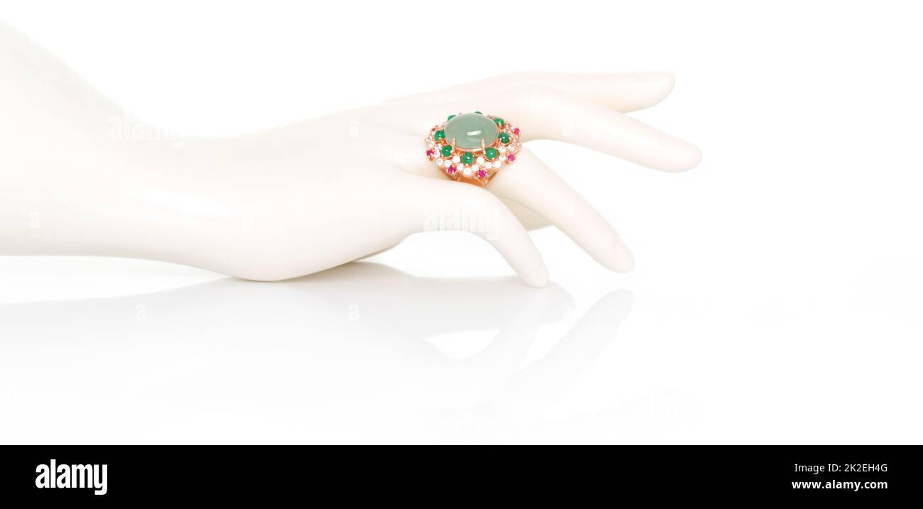 Aquamarine with Emerald, Ruby and white Zircon ring on plastic mannequin female hand. Collection of natural gemstones accessories. Studio shot Stock Photo