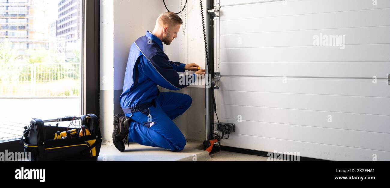 Garage Door Installation And Repair At Home. Contractor Man Stock Photo