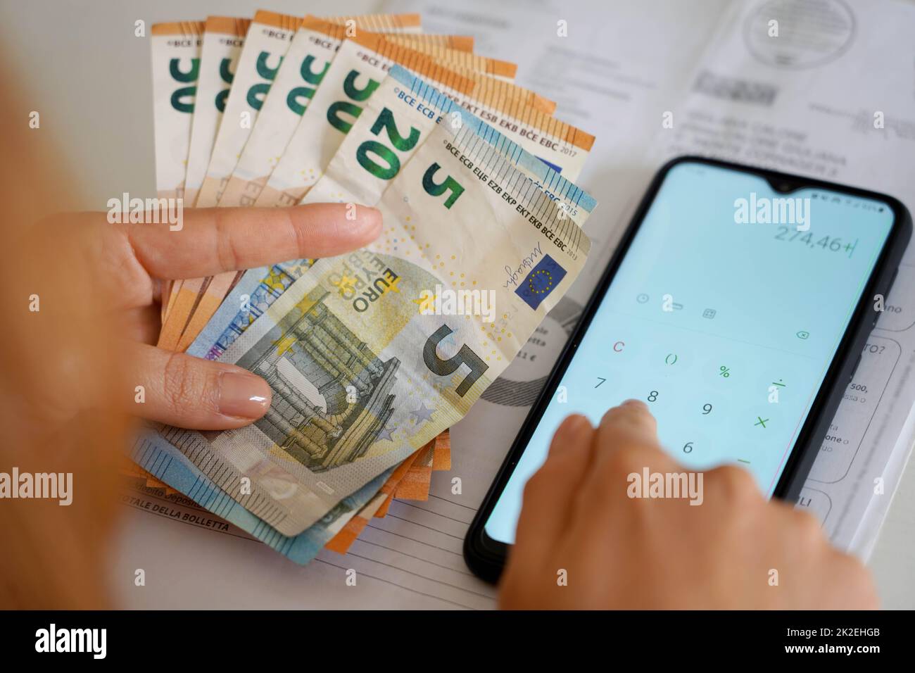 Rise in prices of energy bills during economic crisis. Woman counting expenses electricity bill or gas bill. Stock Photo