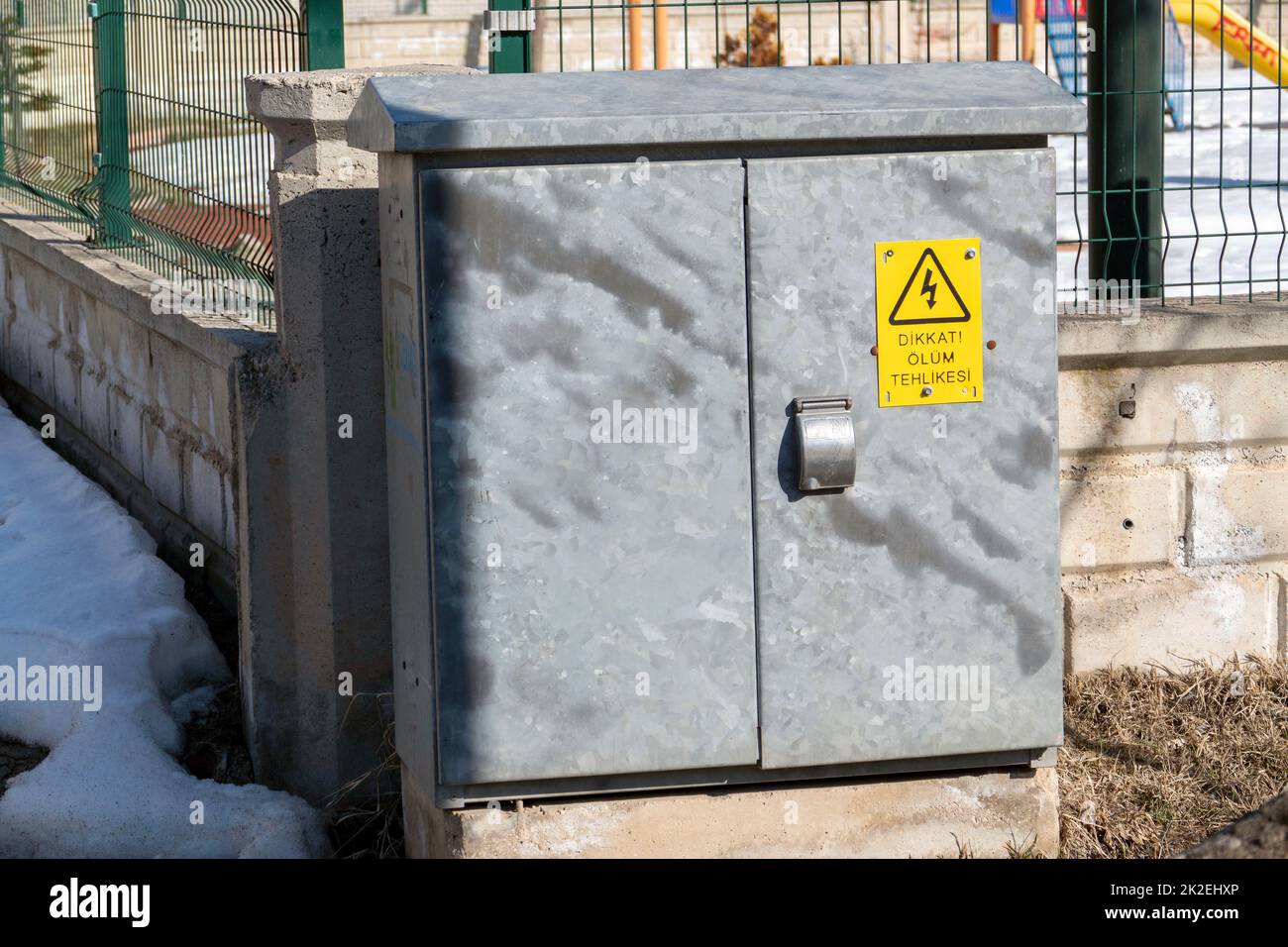 electrical panel standing on the street and warning signs on it