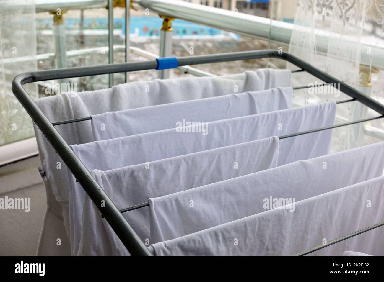drying clothes on the balcony in winter, white clothes drying on the