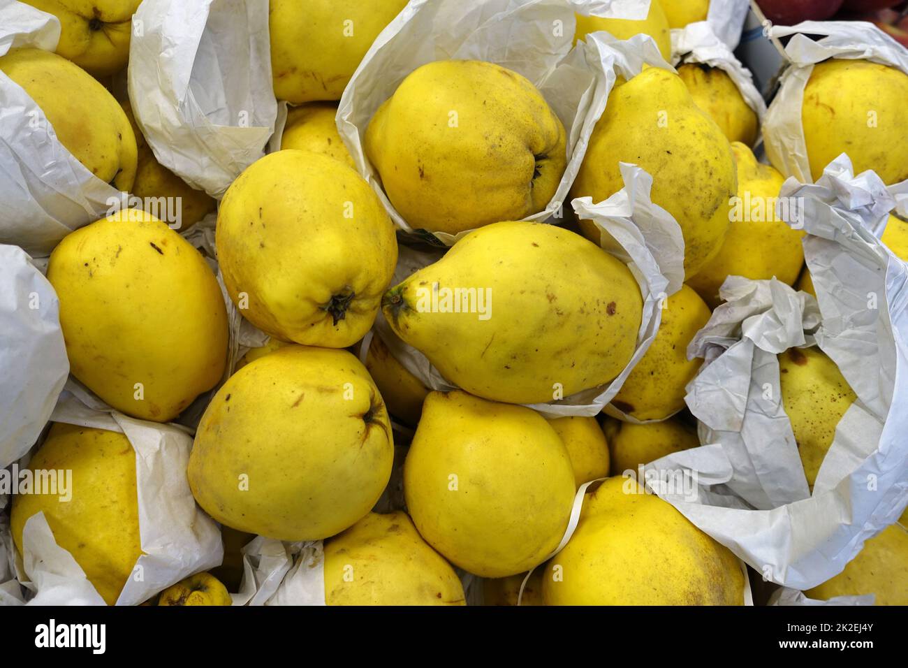 greengrocer, juicy quinces, quince fruit ready for sale, crates of quinces in the supermarket