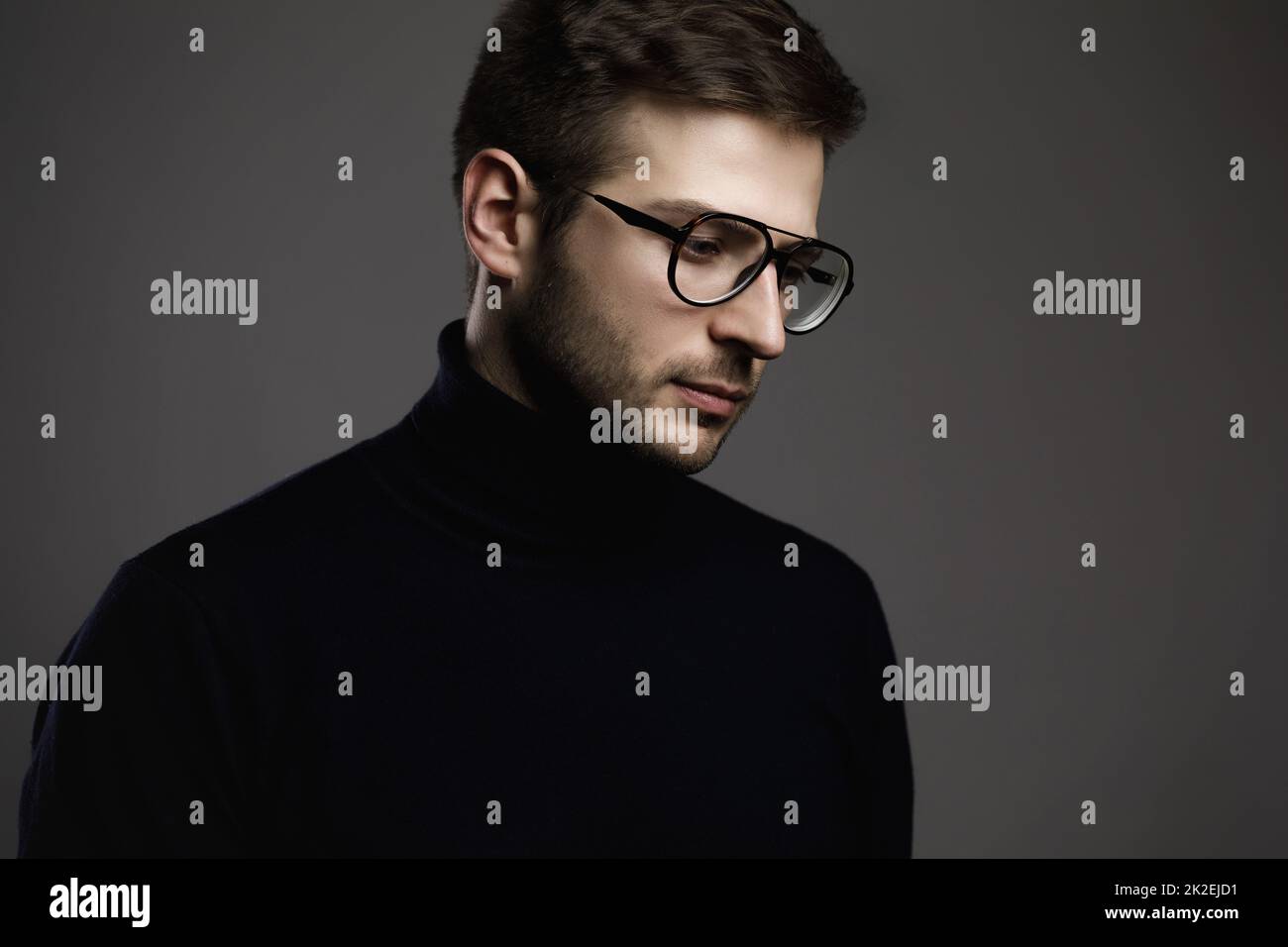 Young smart man wearing glasses and a folded polo neck Stock Photo