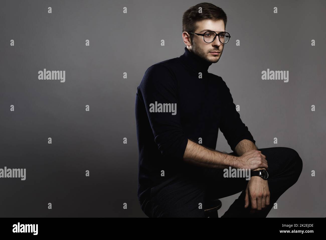 Young smart man wearing glasses and a folded polo neck Stock Photo