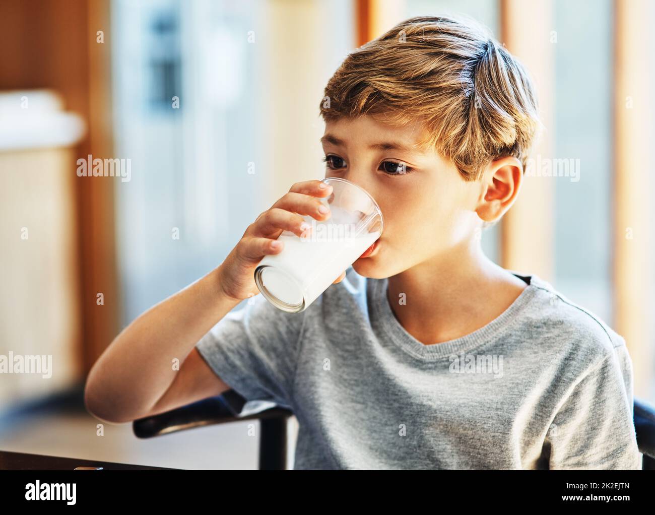 Getting his daily dose of calcium. Shot of a young boy drinking a glass of milk at home. Stock Photo