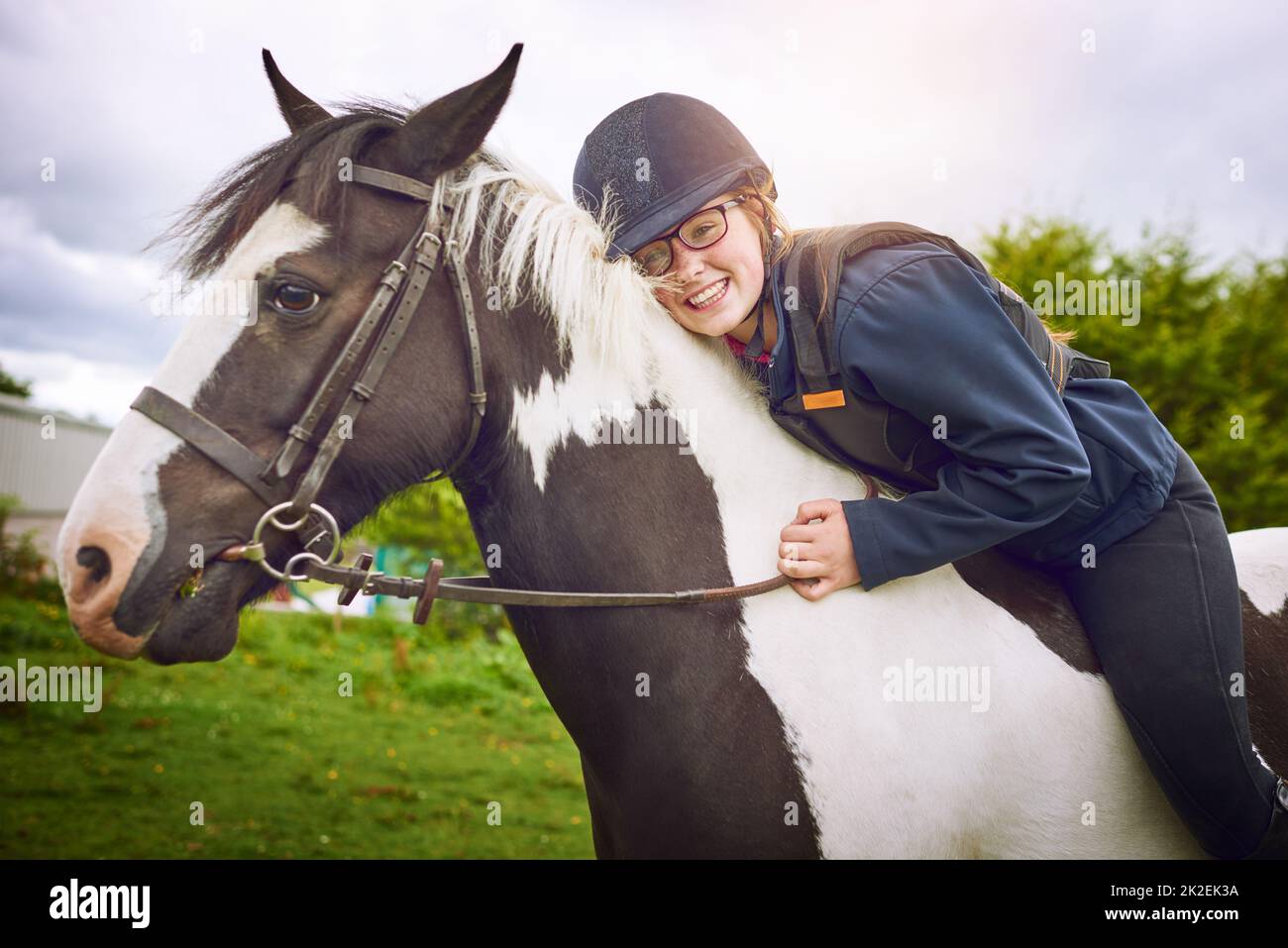 No one makes her as happy as her horse. Shot of a teenage girl going horseback riding on a ranch. Stock Photo