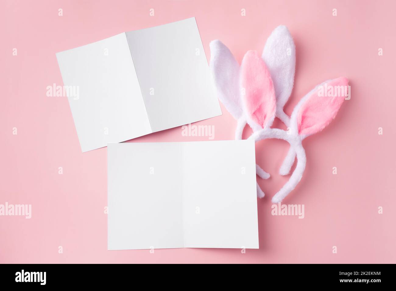 Easter mockup with decorative rabbit ears. Delicate Easter blanks for design on pink background. Stock Photo