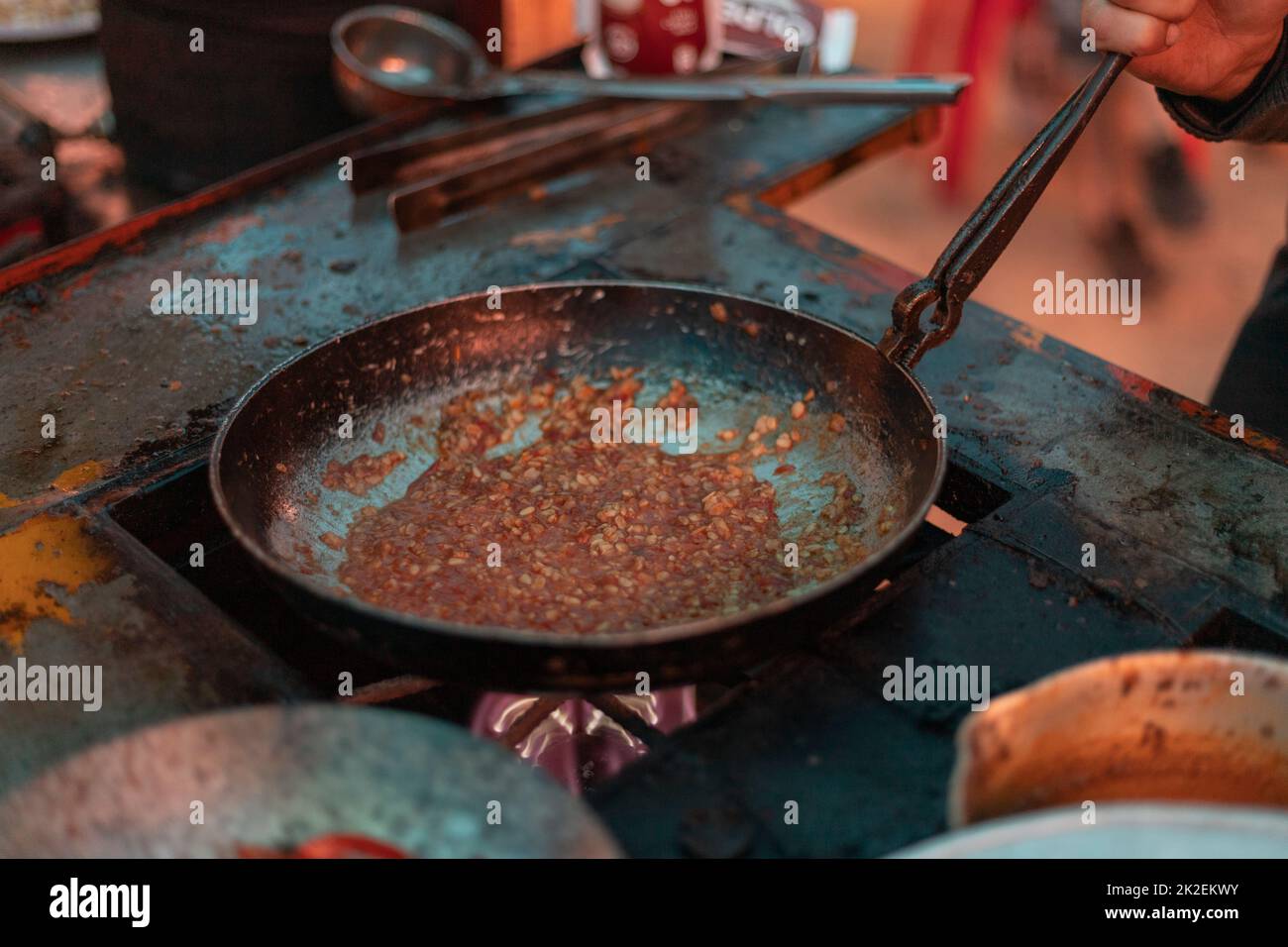 Frying dal pulses in a fry pan. Dal Tadka or Daal fry Pakstani and indian cuisine tasty food. Stock Photo