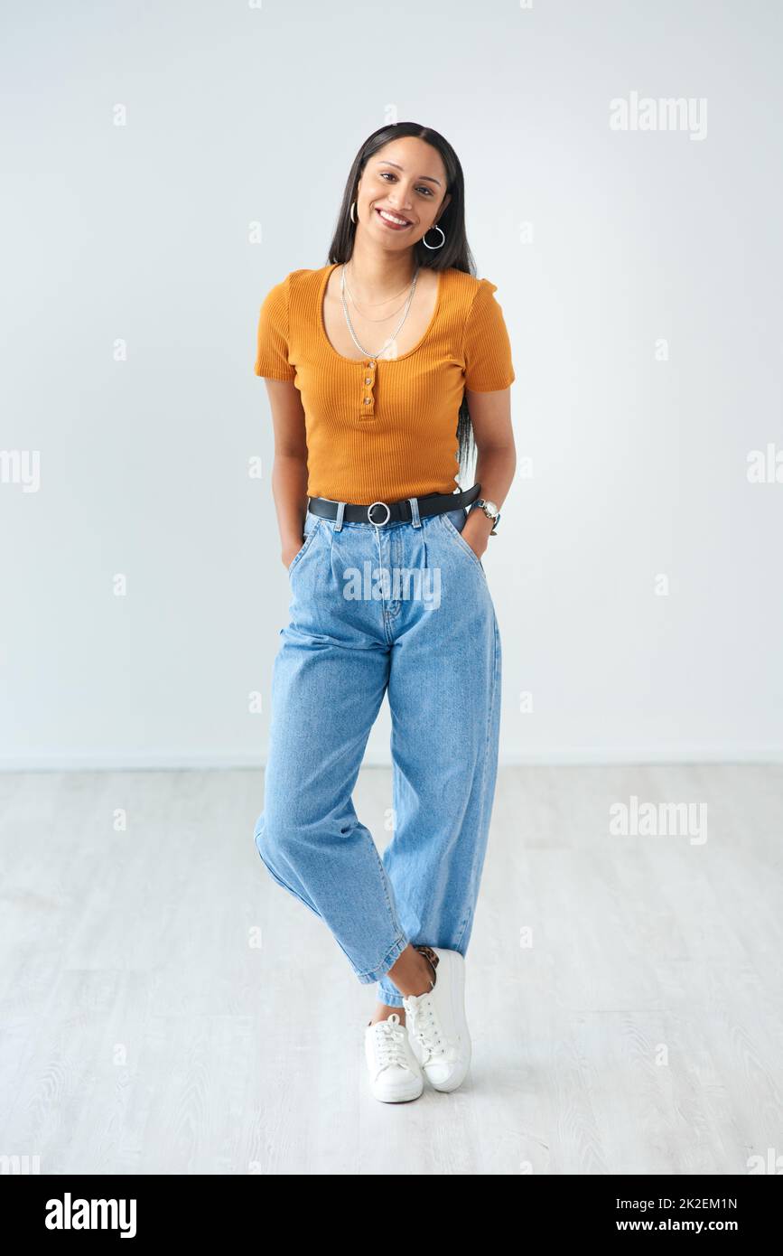 Shes got stye. Full length portrait of an attractive young woman standing with her hands in her pockets in studio. Stock Photo