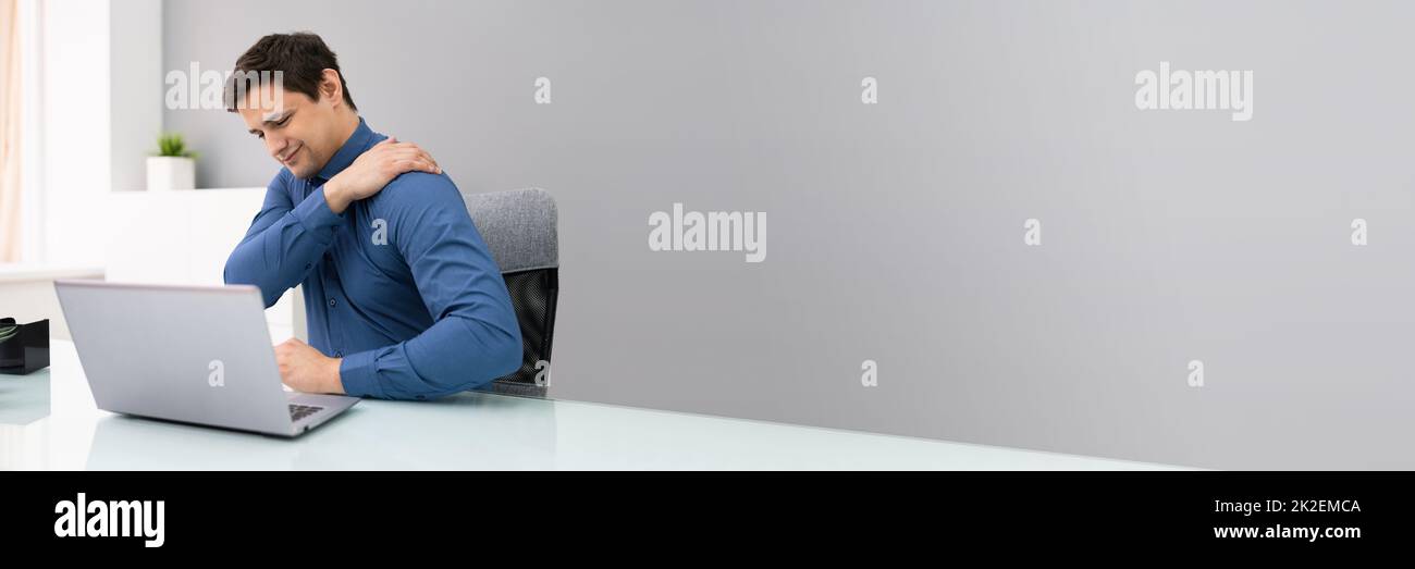 Mature Businessman Suffering From Shoulder Pain Stock Photo
