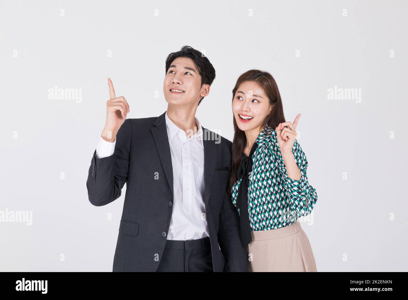 Korean young couple, man and woman wearing modern Hanbok giving directions Stock Photo