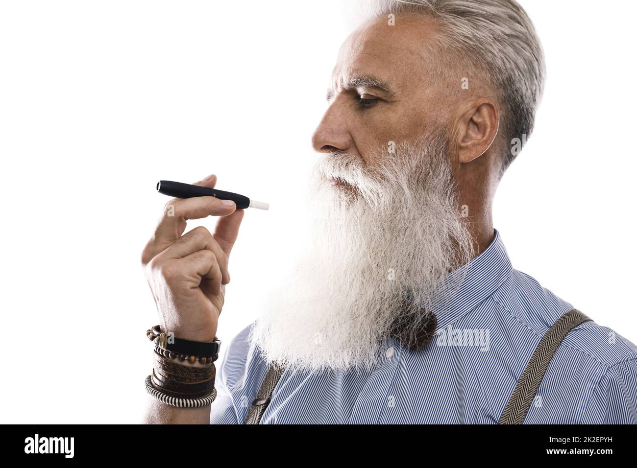 Handsome senior man smoking tobacco heating system Stock Photo
