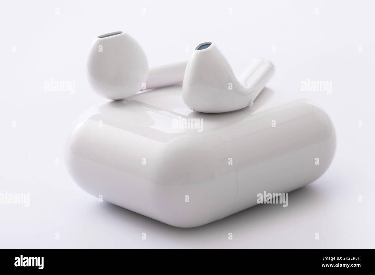 White wireless earphones with a charging box Stock Photo