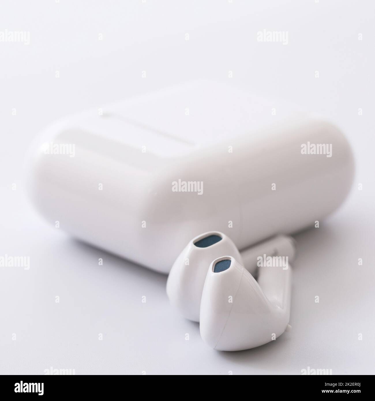 white wireless earphones with a charging box Stock Photo
