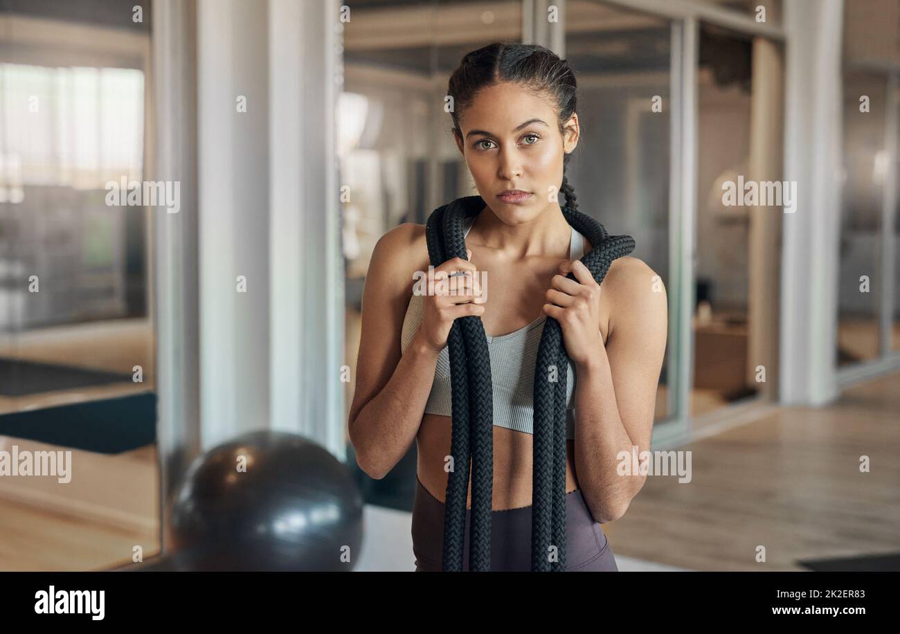 Im a lot tougher than I look. Shot of a young female athlete posing with a rope around her neck. Stock Photo