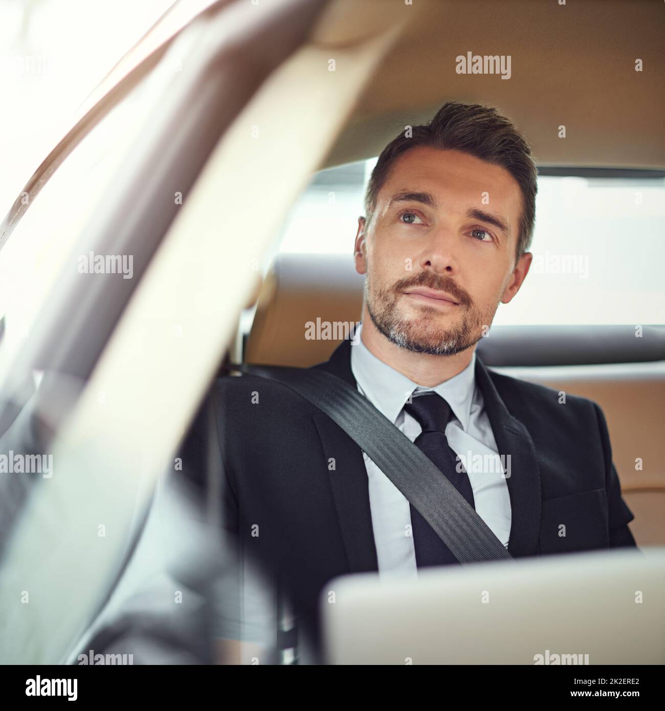Thinking about the day ahead. Cropped shot of a businessman in the backseat of a car. Stock Photo