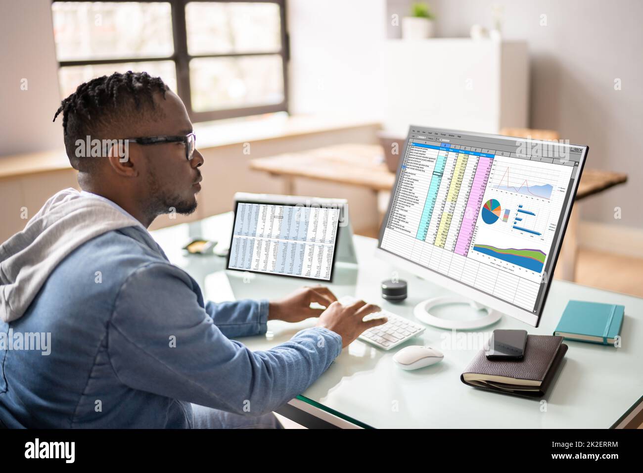 African American Auditor Using Electronic Spreadsheet Stock Photo