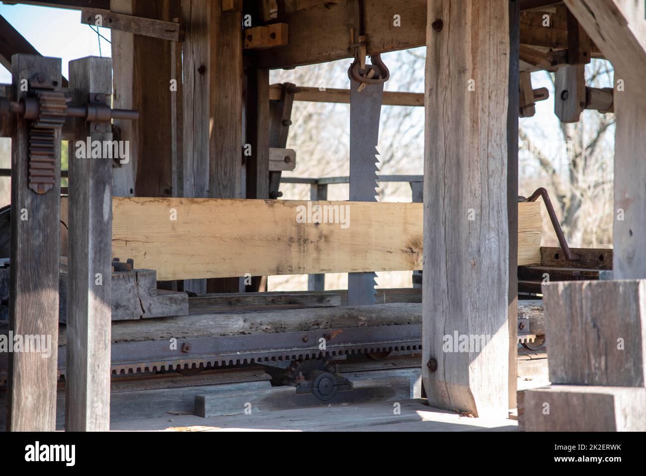 Vertical saw milling lumber in colonial American sawmill Stock Photo