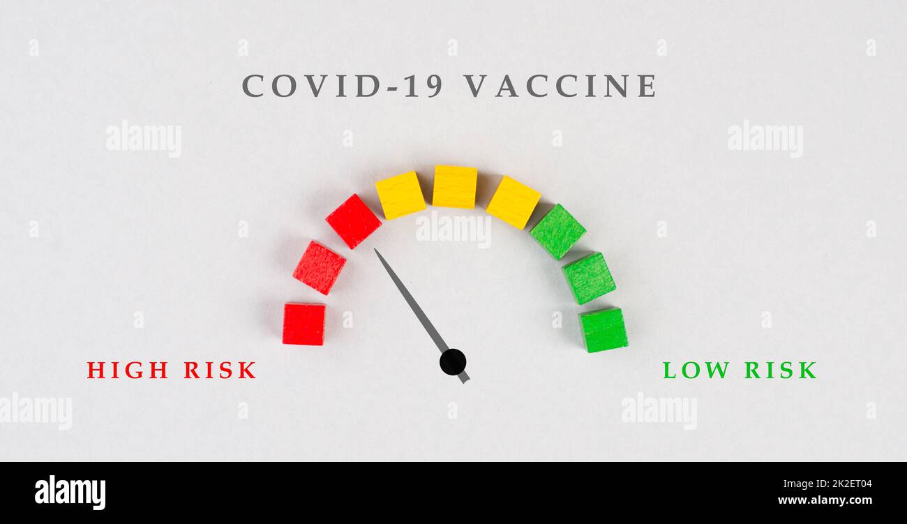 Safety of covid-19 vaccination, high and low risk, arrow is pointing to the red risky area, medical issue Stock Photo