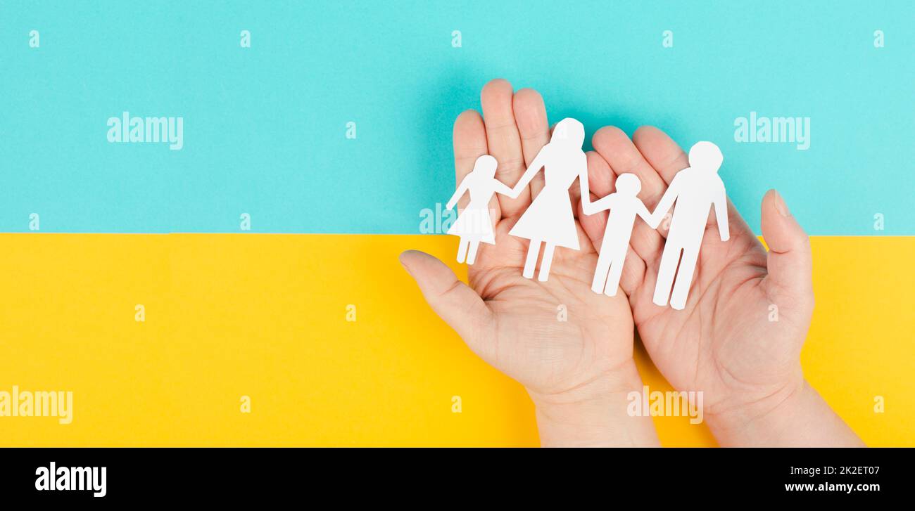 Parents with two child holding hands, family life, paper cut out, copy