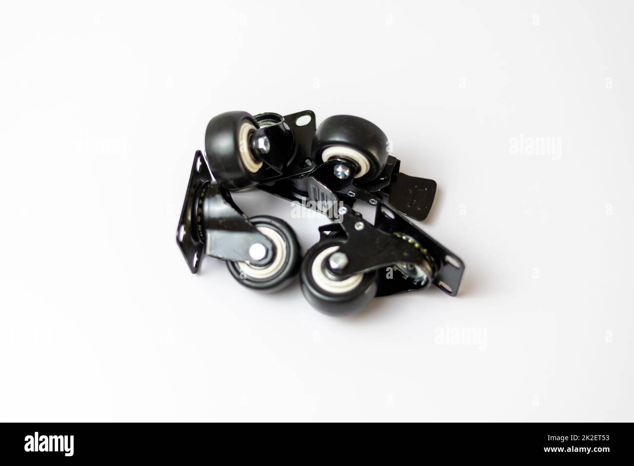 Black rubber tyre with lock function on a white isolated background with selective focus Stock Photo