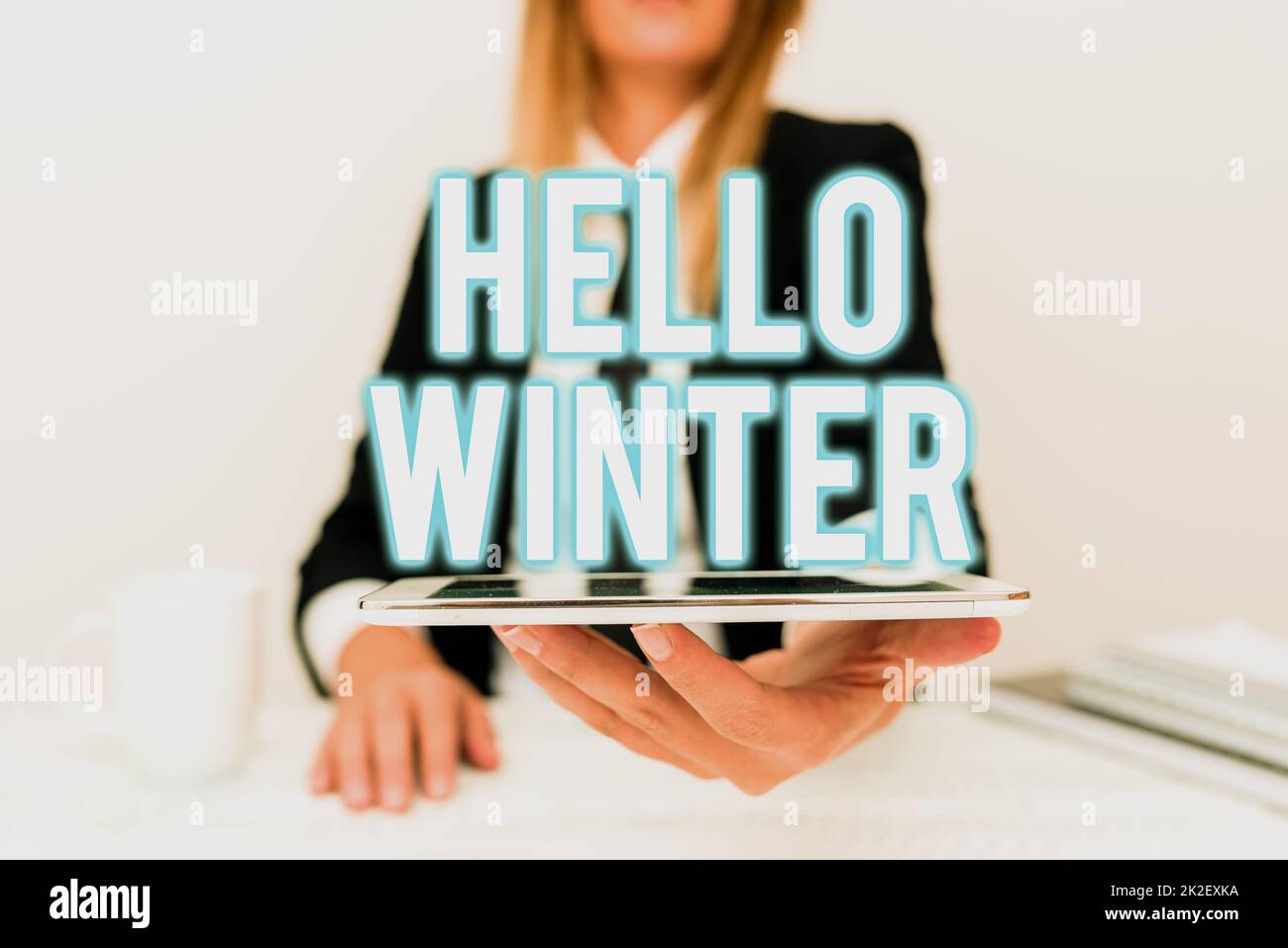 Text sign showing Hello Winter. Conceptual photo coldest season of the year in polar and temperate zones App Developer Presenting New Program, Displaying Upgraded Device Stock Photo