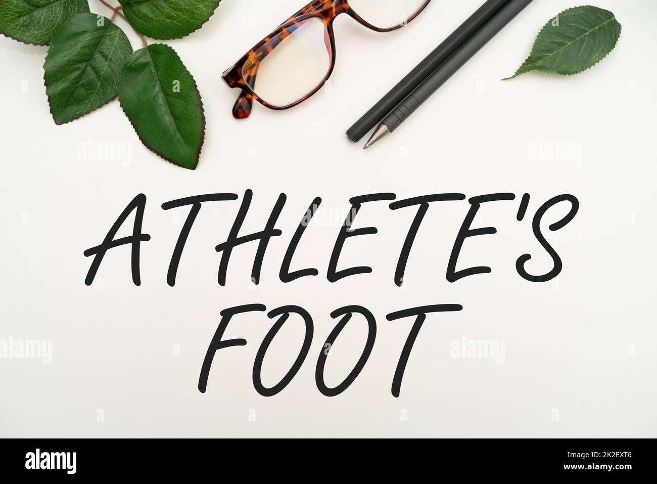 Text showing inspiration Athlete S Is Foot. Business showcase a fungus infection of the foot marked by blisters Office Supplies Over Desk With Keyboard And Glasses And Coffee Cup For Working Stock Photo