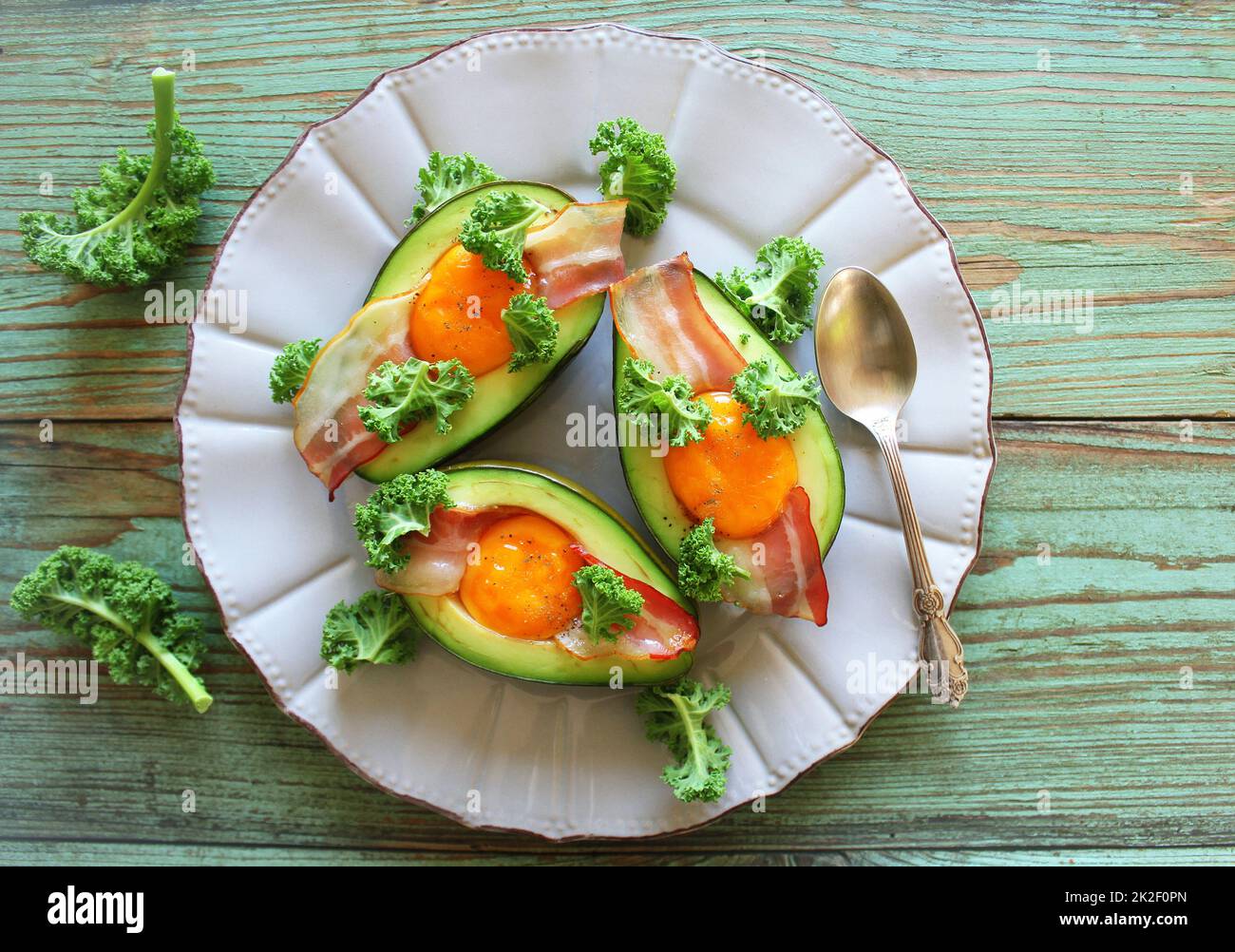 Breakfast. Avocado Egg Boats with crunchy bacon, kale cabbage. Top view