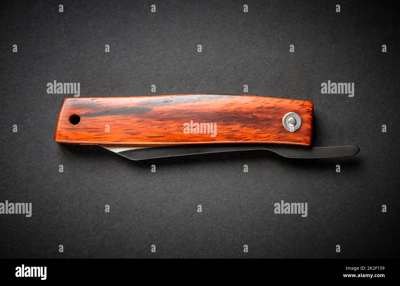 Traditional wooden japanese pocket knife on black background Stock