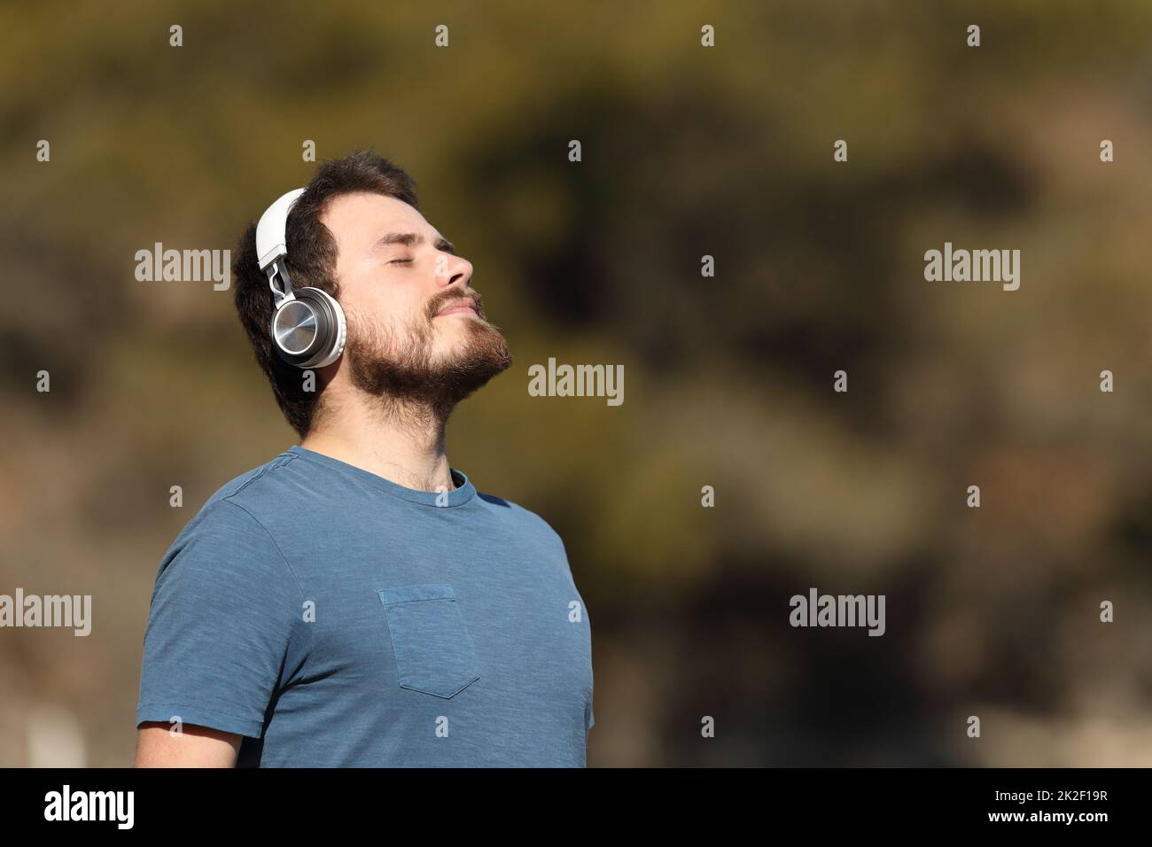 Man relaxing meditating listening audio guide Stock Photo