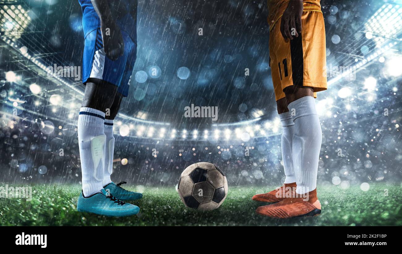 Two soccer players challenge each other at the stadium Stock Photo