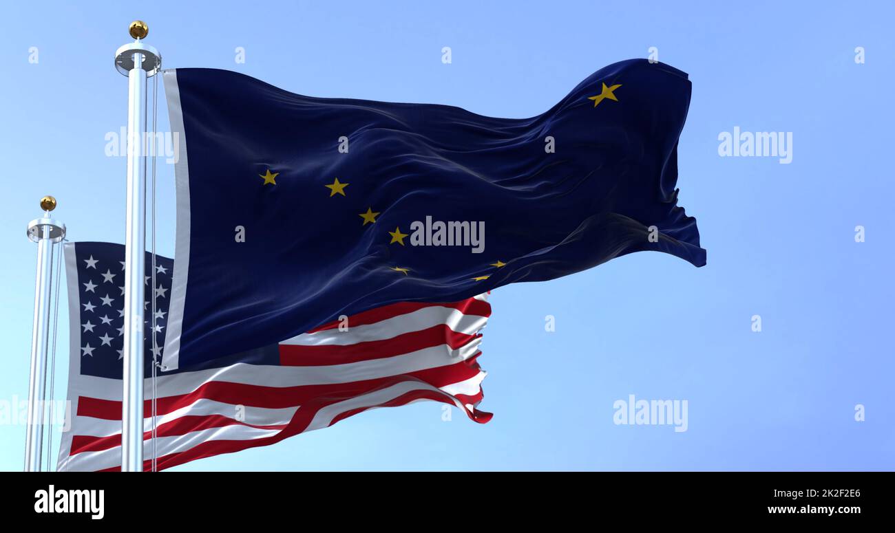 The Flags Of The Alaska State And United States Waving In The Wind