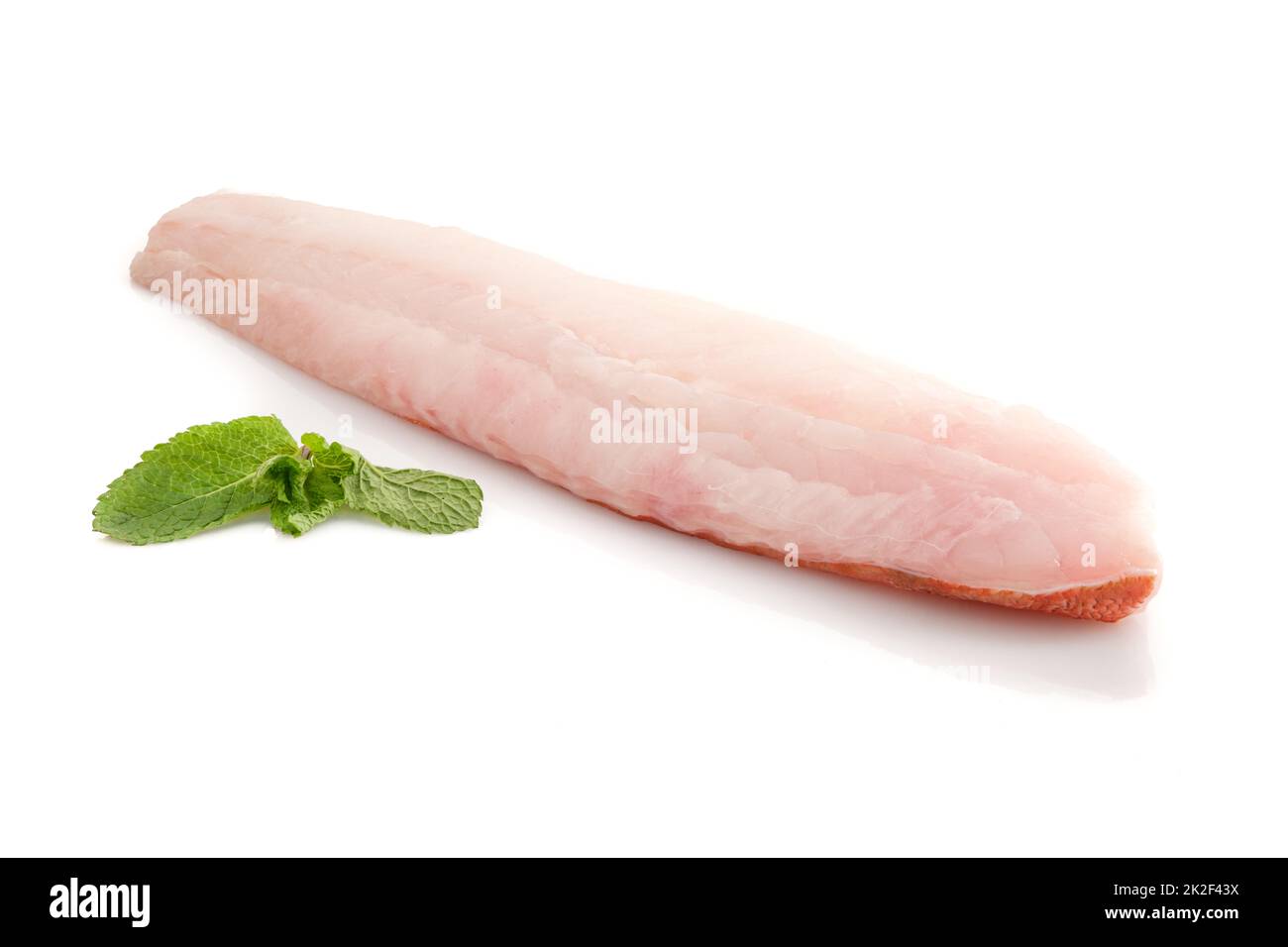 Redfisch filet with green mint leaves on white isolated Stock Photo