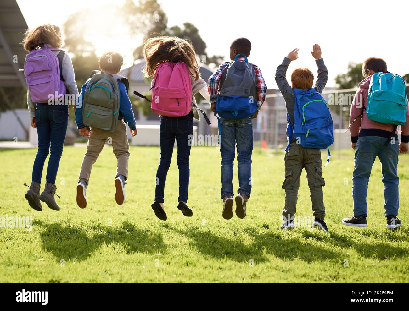 Jump for joy, its holiday. Shot of young kids playing together outdoors. Stock Photo