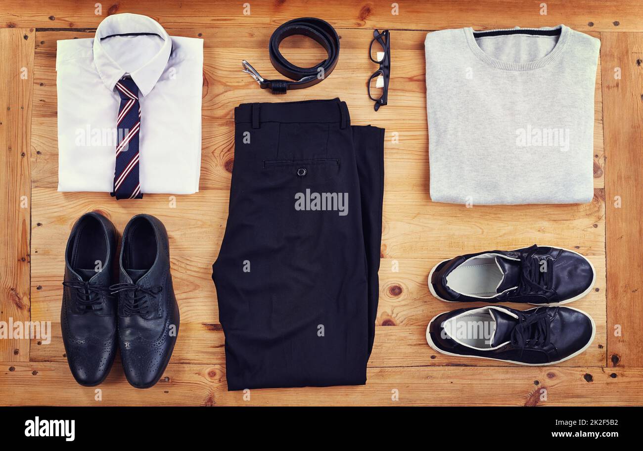 Smart or casual. High angle shot of a smart and a casual outfit laid out on a wooden table. Stock Photo