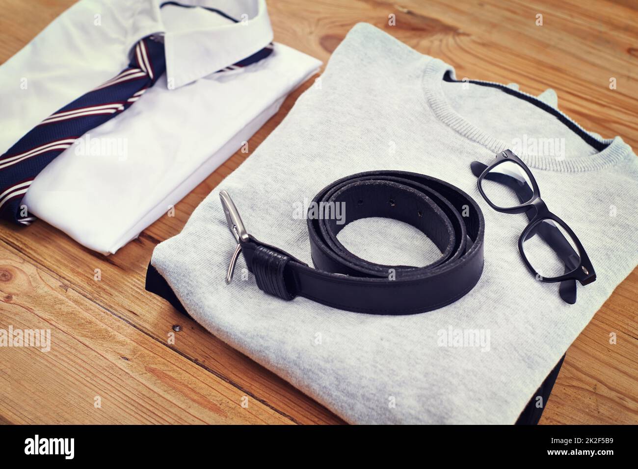 Fashion for every occasion. High angle shot of a smart and a casual shirt laid out on a wooden table. Stock Photo