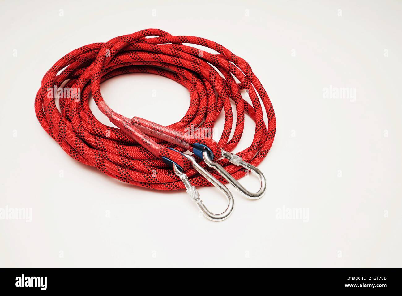 Red climbing rope on white background Stock Photo