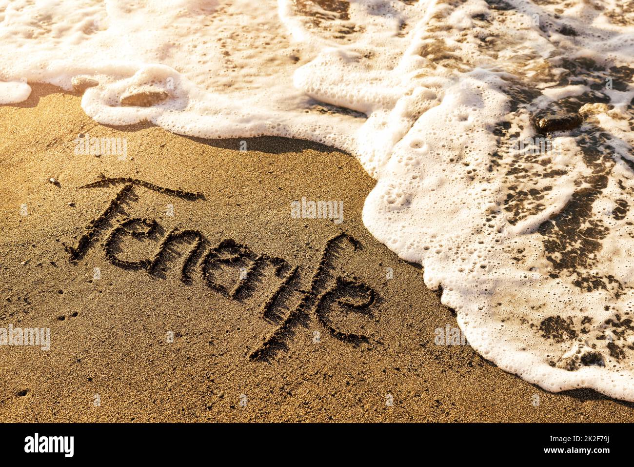 Tenerife text on volcanic beach black sand Stock Photo