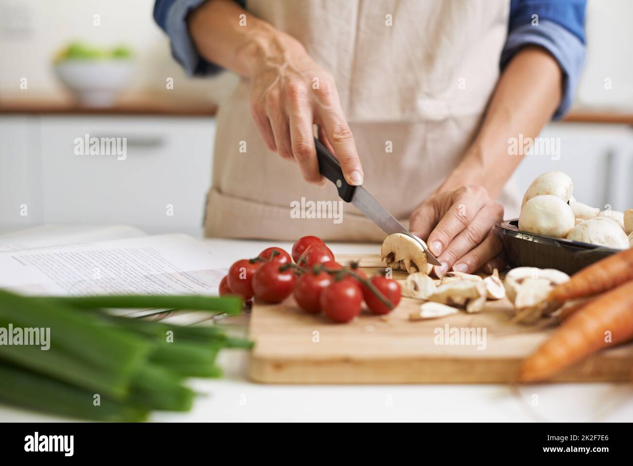 Slice and dice. an attractive young woman chopping vegetables in a kitchen  Stock Photo - Alamy