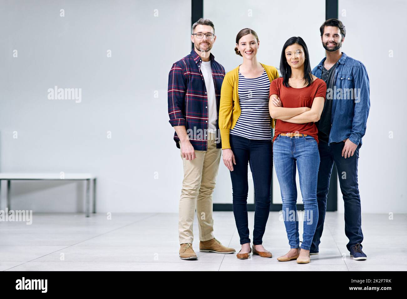Portrait of a group of creatives standing together in an office Stock