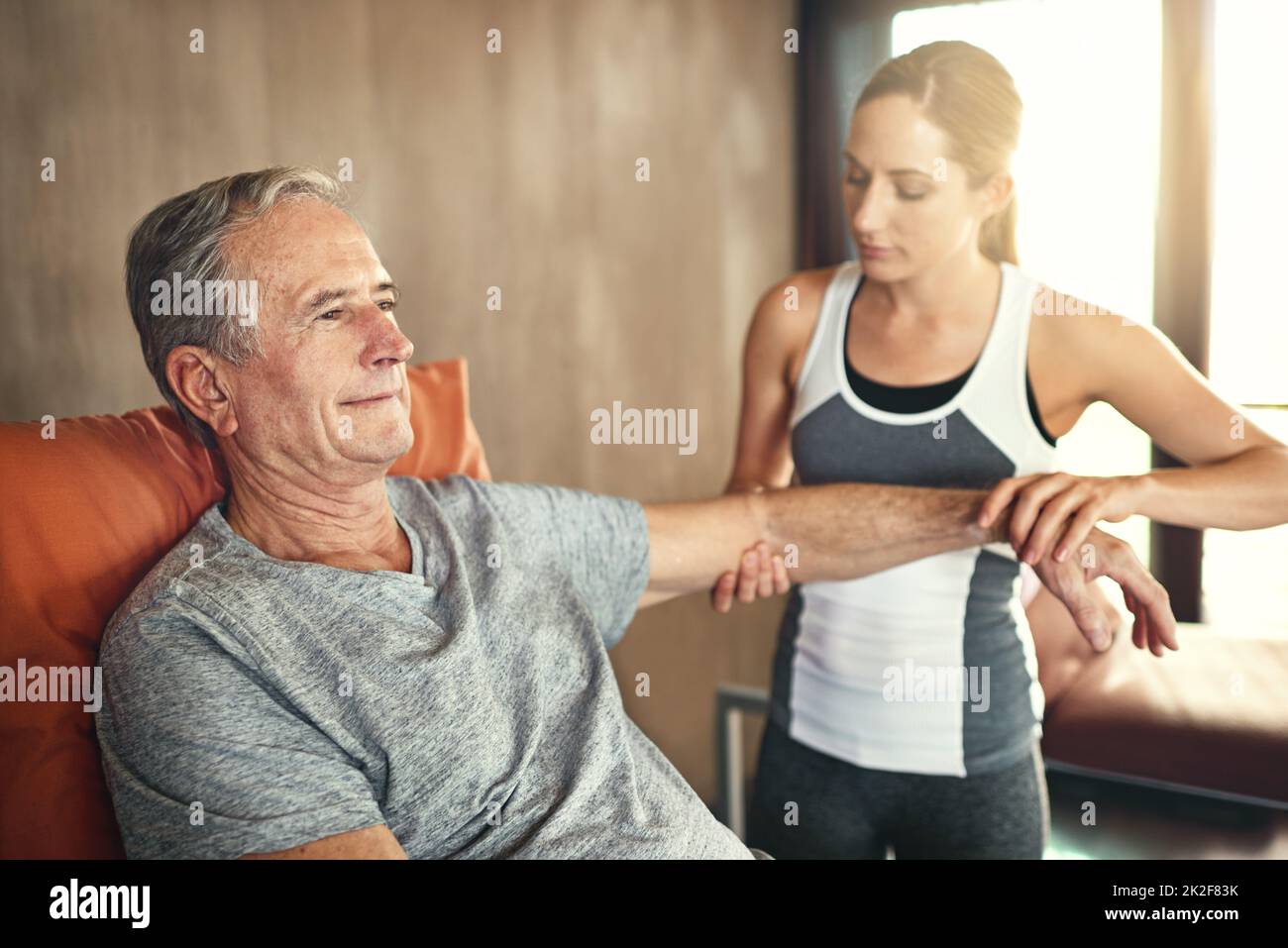 She has an aptitude for caring for others. Shot of a senior man being treated by a physiotherapist. Stock Photo
