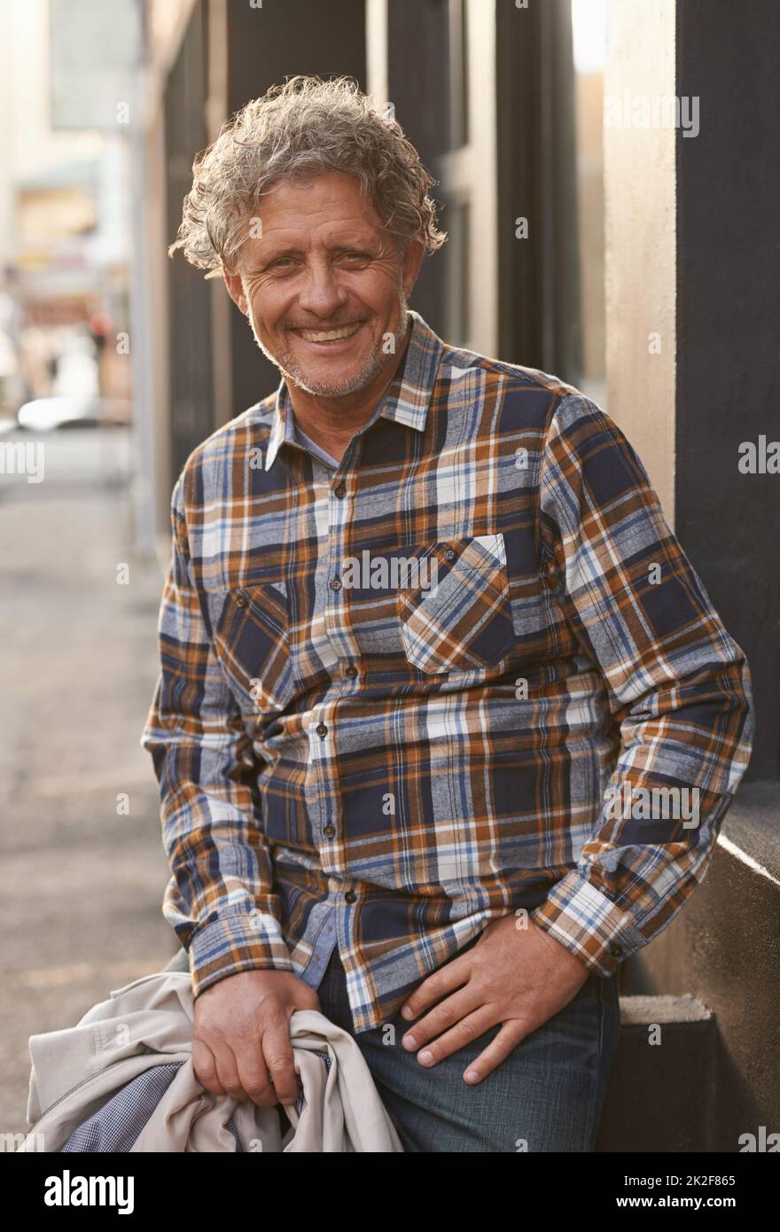 Style is timeless. Portrait of a friendly-looking middle aged man outside. Stock Photo