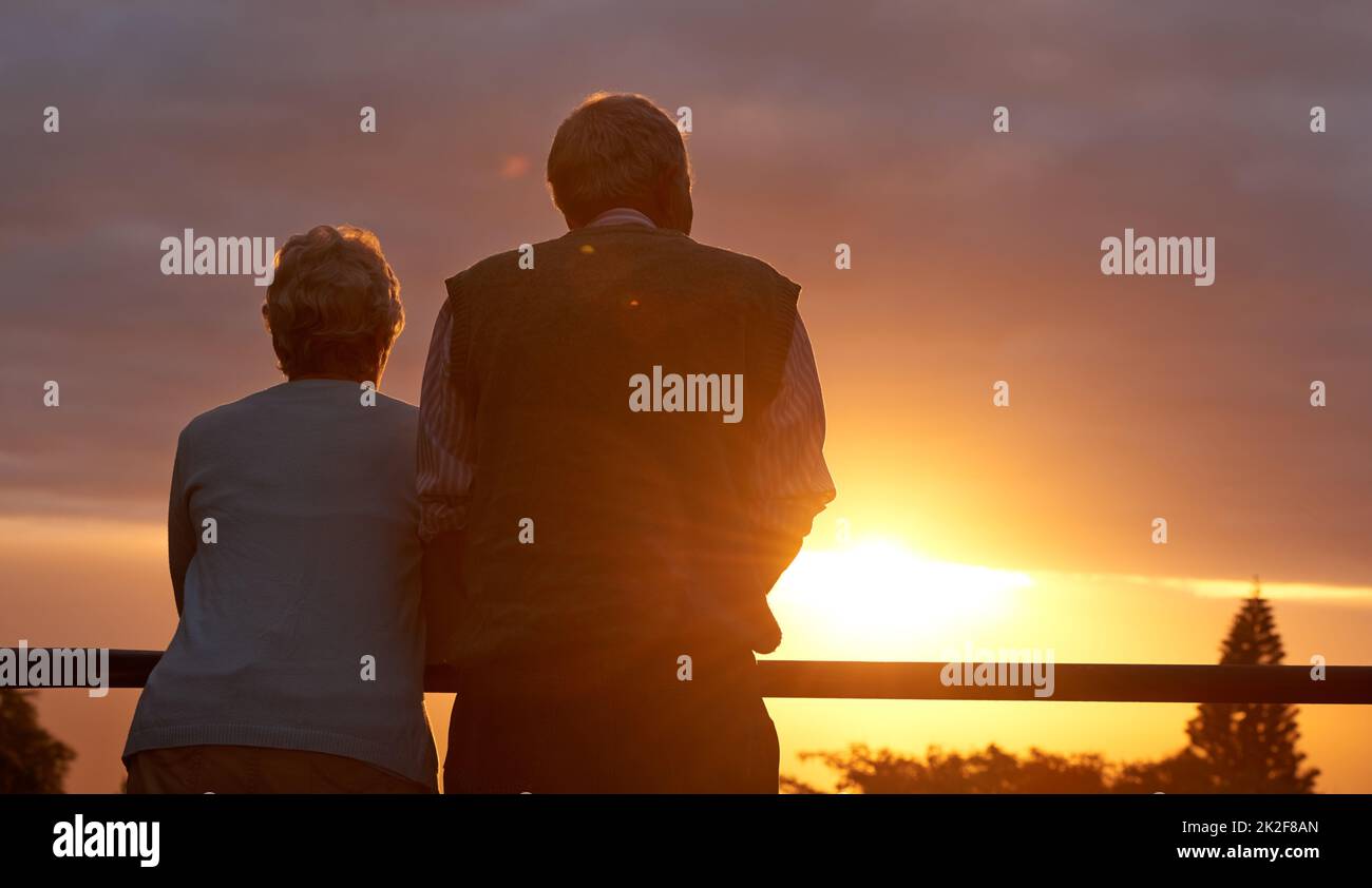 They still love romance. Cropped shot of an elderly couple sharing a romantic moment at sunset. Stock Photo