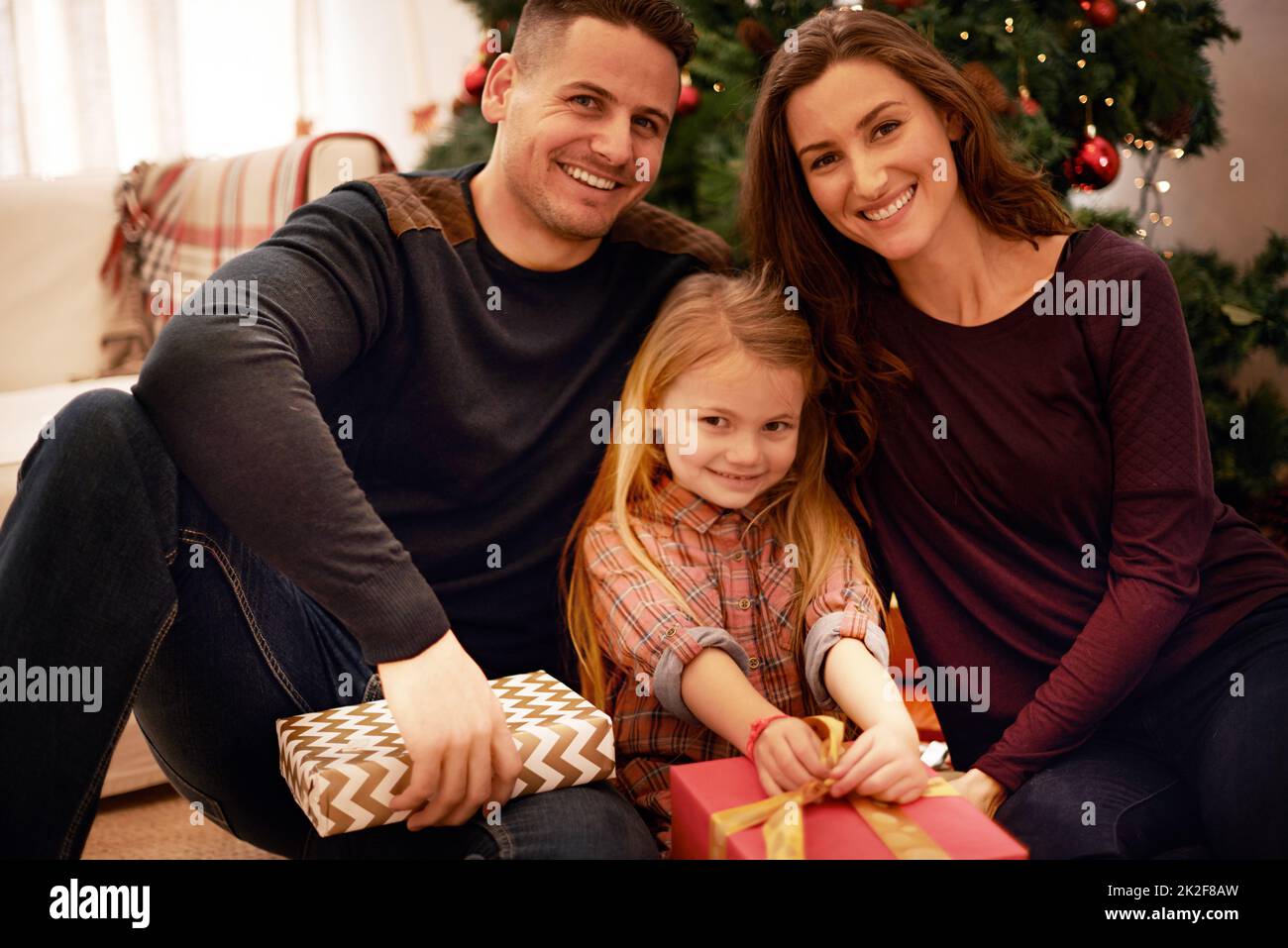 Feeling the festive cheer. Portrait of a young family celebrating Christmas. Stock Photo