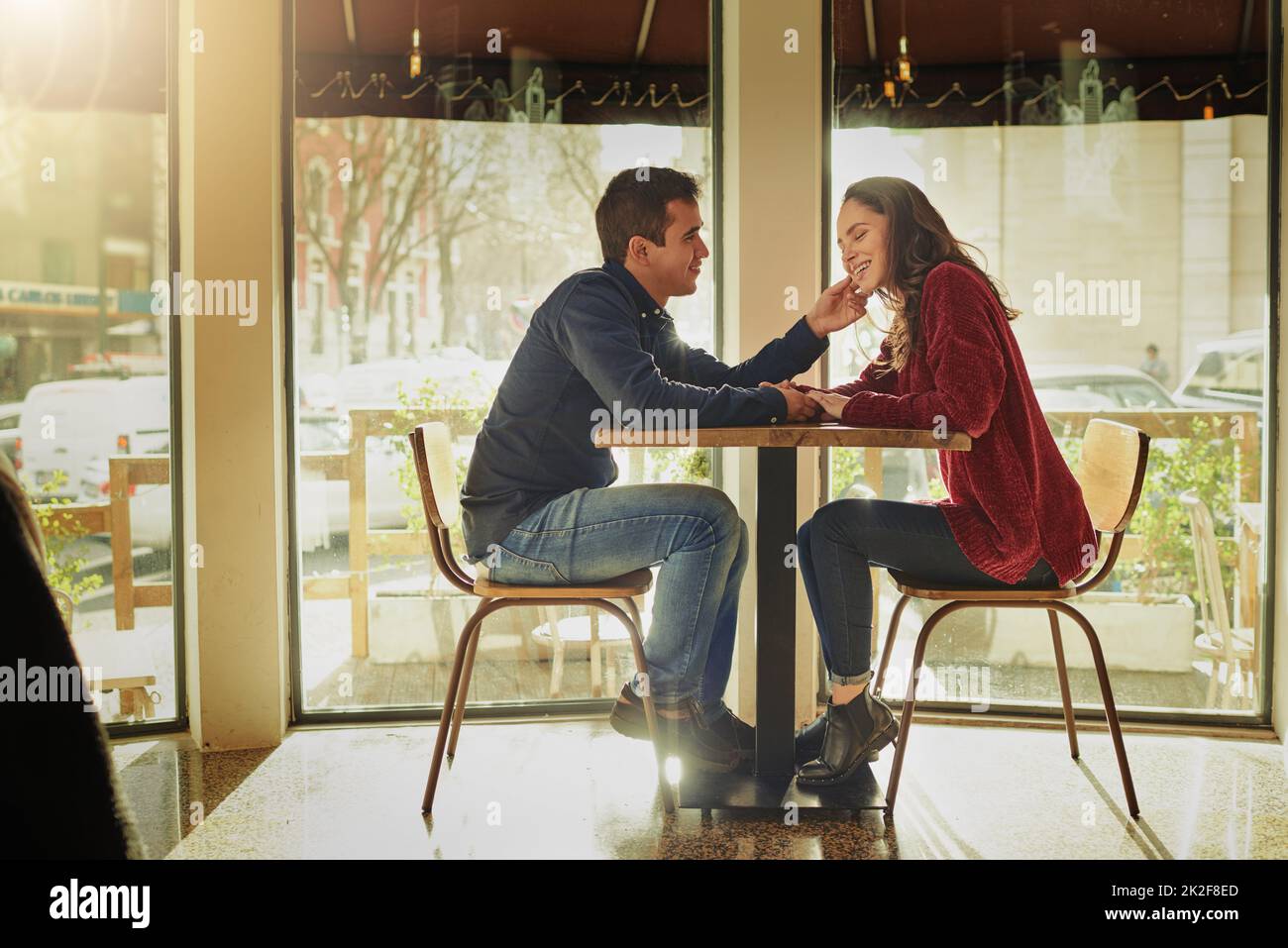 Theres always room for romance. Shot of a young man and woman on a romantic date at a coffee shop. Stock Photo