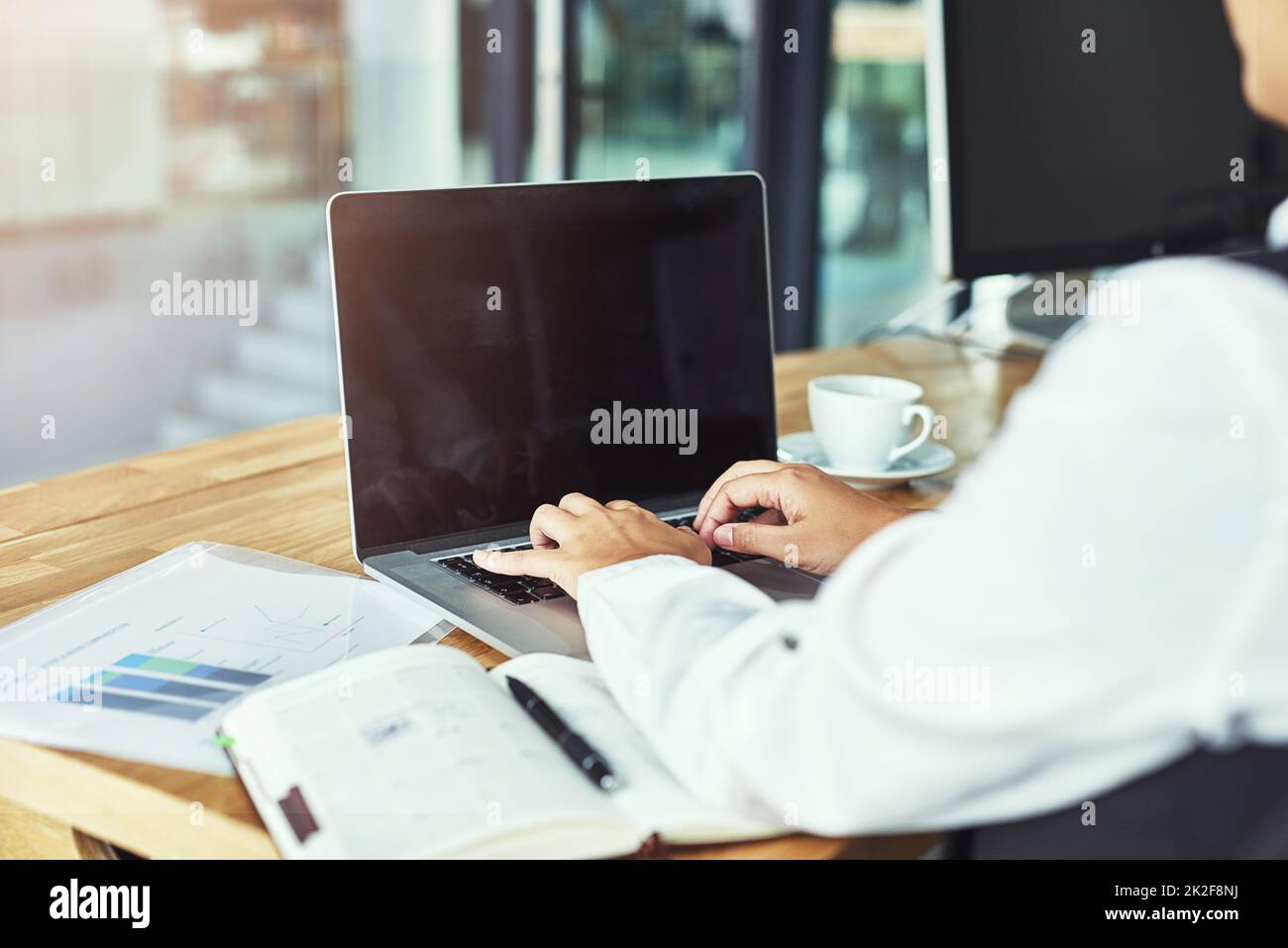 Time to do business. Closeup shot of a businesswoman working on a laptop in a modern office. Stock Photo