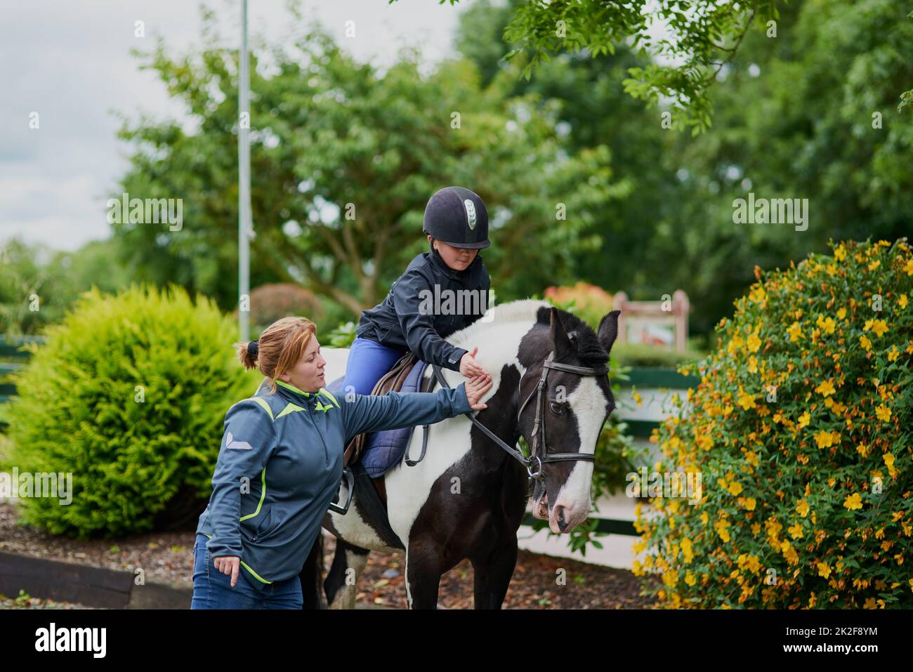 My trainer is helping me succeed. Shot of a horse riding trainer