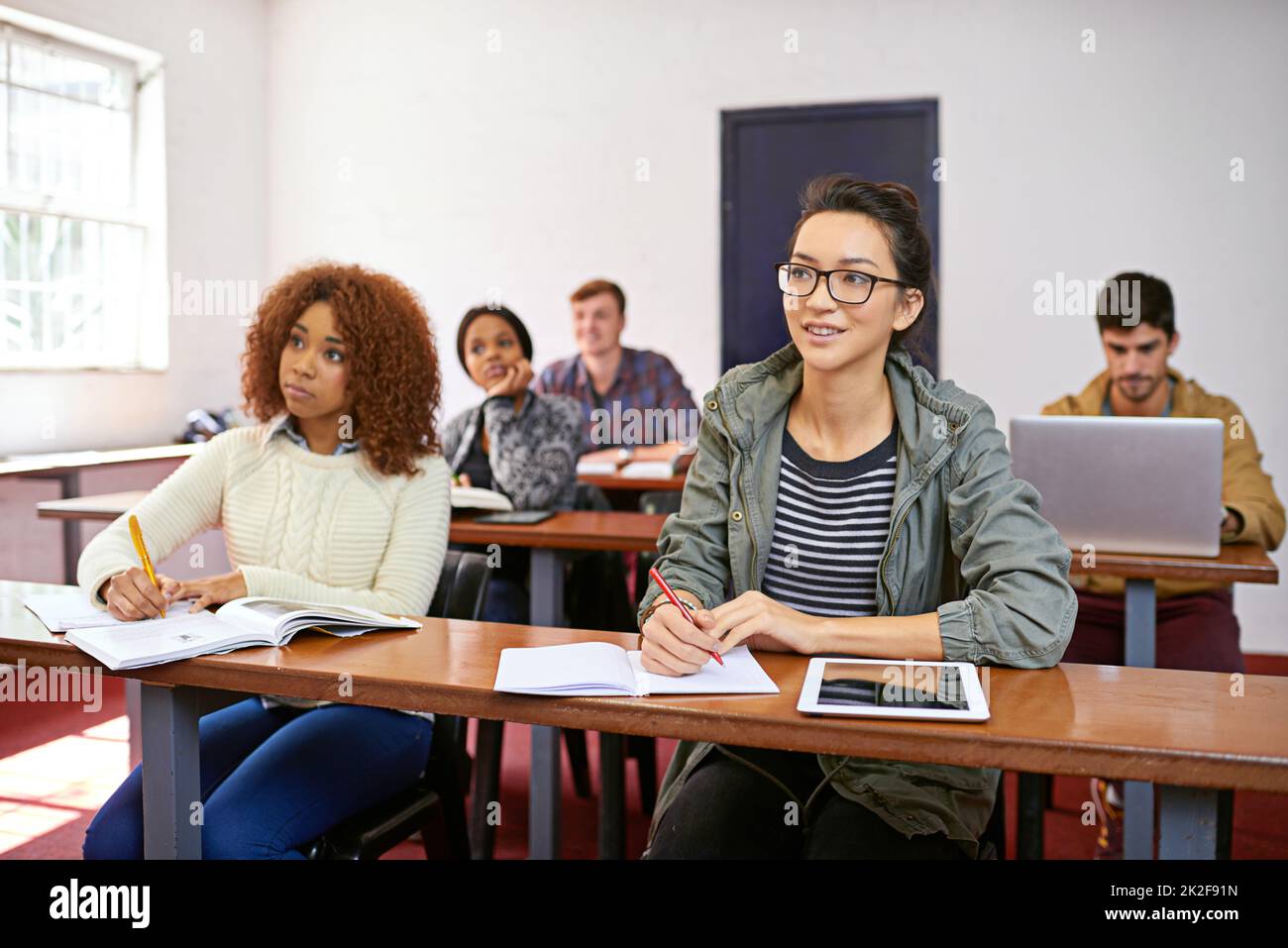 Focused on absorbing information. Shot of a university students paying attention in class. Stock Photo