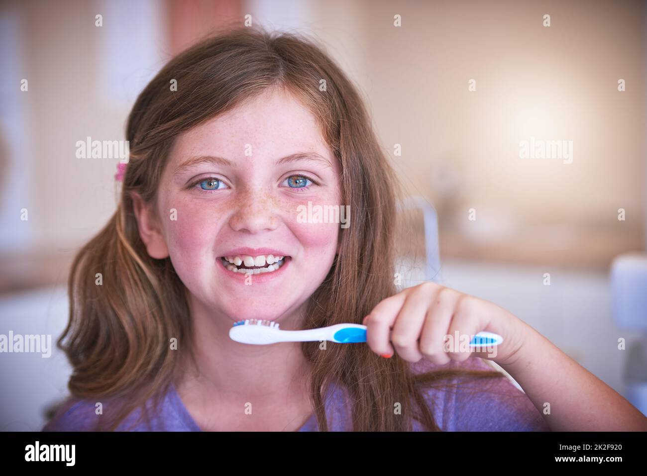 Making sure my pearly whites stay pearly. Cropped shot of a little girl brushing her teeth. Stock Photo