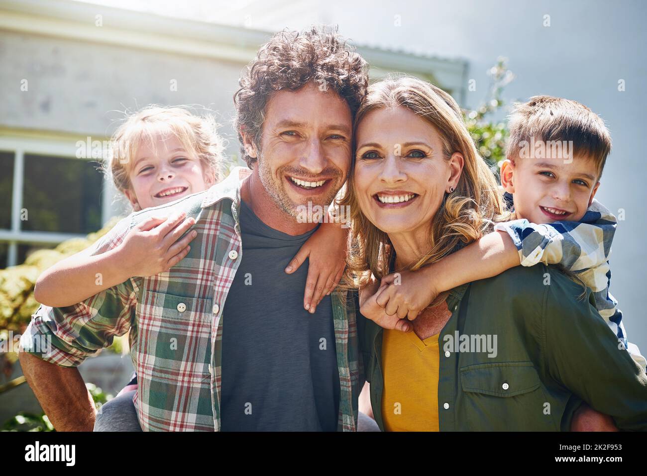 All you need is family to be truly happy. Portrait of a happy family spending time together outdoors. Stock Photo